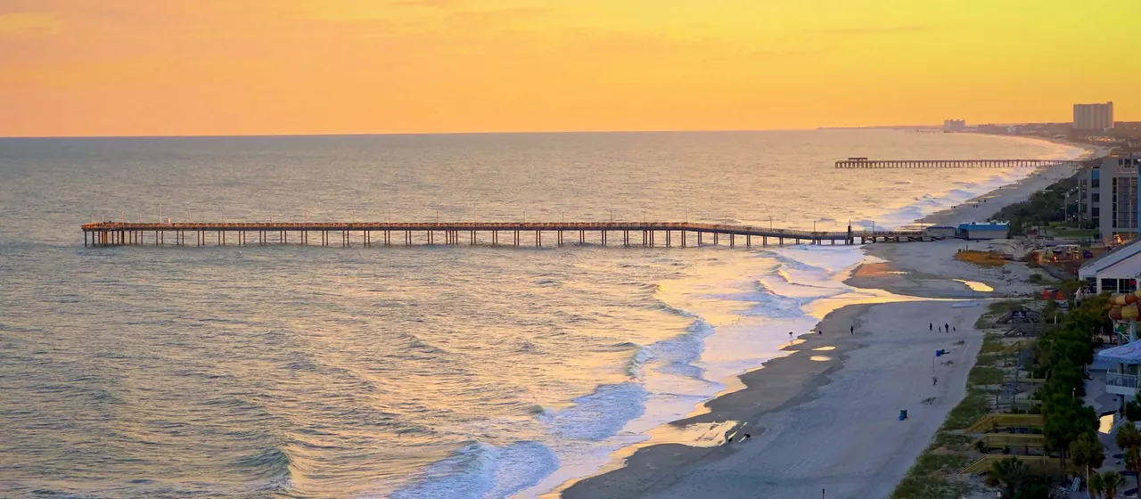 Aerial view of the Myrtle Beach coastline and pier at sunset