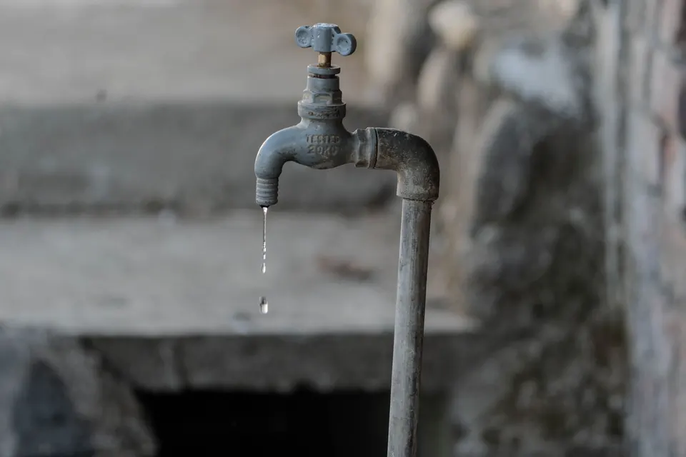 An outdoor tap dripping water