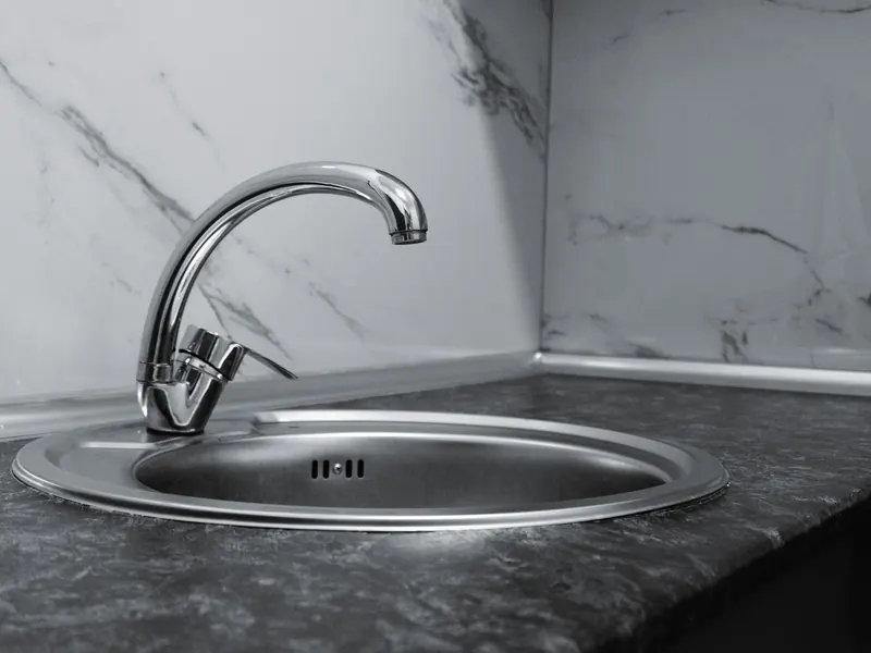 A stainless steel kitchen sink with a chrome faucet